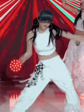 a woman wearing a hat that says rosa is dancing on a stage