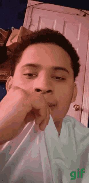 a gif of a man covering his mouth with a napkin