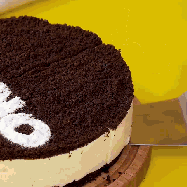 a cake with the word oreo on it is being sliced