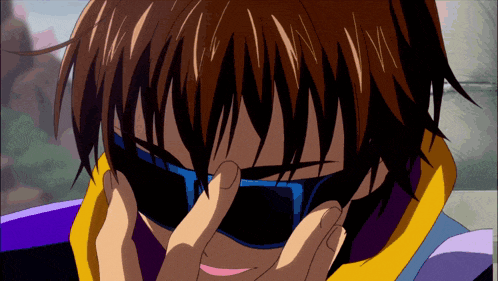 a person wearing sunglasses covering their face with their hands