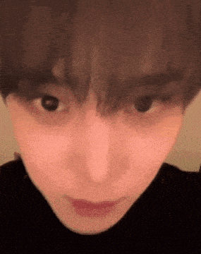 a close up of a person 's face with a black turtleneck .