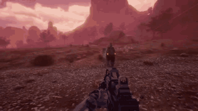 a person holding a gun in a video game with a purple sky in the background .