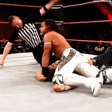 a man in a wrestling ring with the word impact on the side