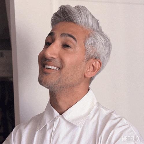 a man with gray hair and a white shirt that says netflix on the sleeve