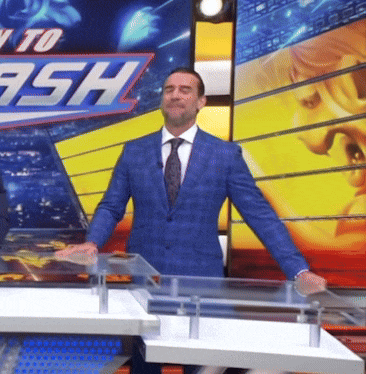 a man in a suit and tie is standing in front of a sign that says ready to ash