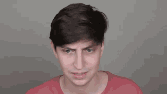 a young man with braces on his teeth is making a funny face