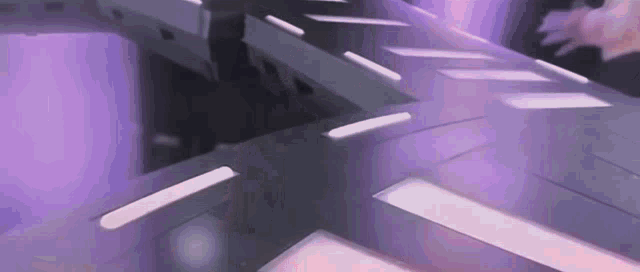 a purple room with a lot of lights on the ceiling and walls .
