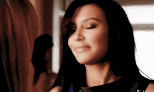 a close up of a woman 's face with #glee written on the bottom