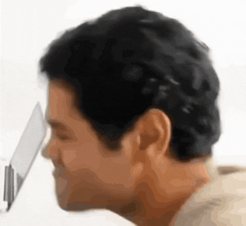 a man 's head is shown in a blurry photo with a white background