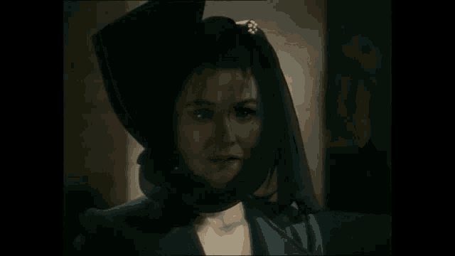 a woman wearing a black hat and a blue jacket