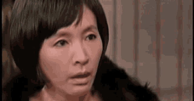a close up of a woman making a funny face .