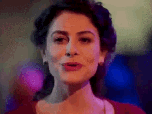 a close up of a woman 's face with a blurred background
