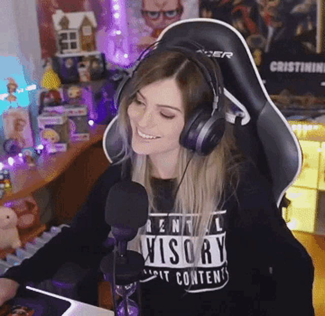 a woman is wearing headphones and a shirt that says advisory