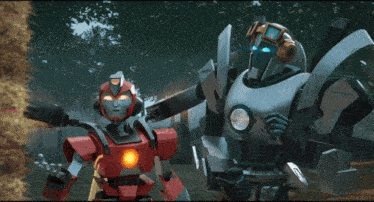 a couple of robots are standing next to each other in a field