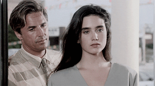 a man and a woman are looking at each other