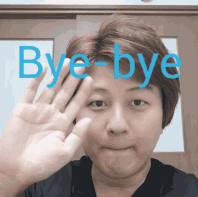 a woman waves her hand in front of a sign that says bye bye