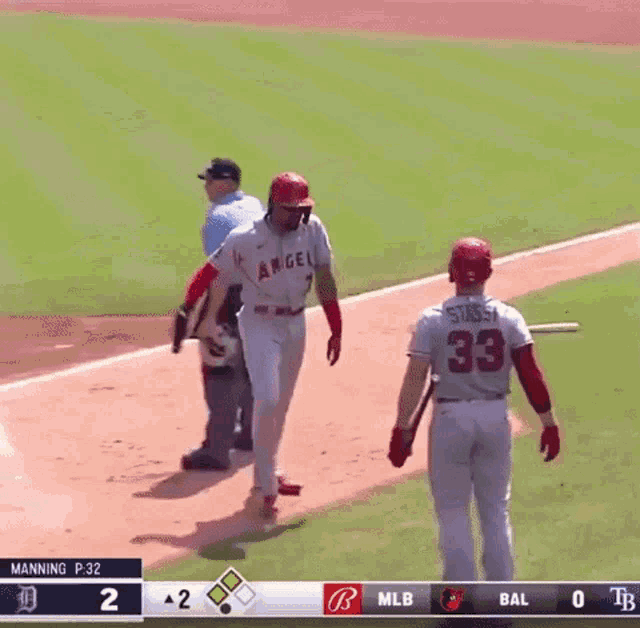 a baseball player with the number 33 on the back of his jersey stands on the field
