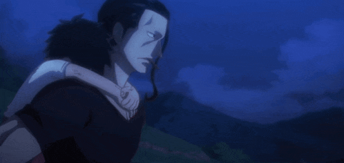a man is holding a child in his arms in a dark scene