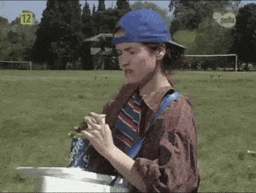 a man in a plaid shirt and tie is holding a sprite can