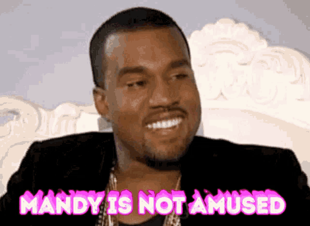 a man with a beard is smiling with the words mandy is not amused behind him