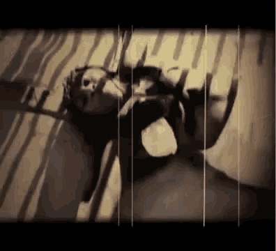 a black and white photo of a woman laying on her back on a bed .