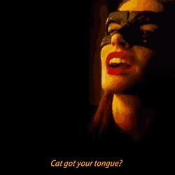 a woman wearing a mask and red lips is asking " cat got your tongue "