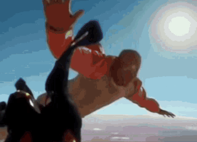 a man in an orange jacket is falling in the air