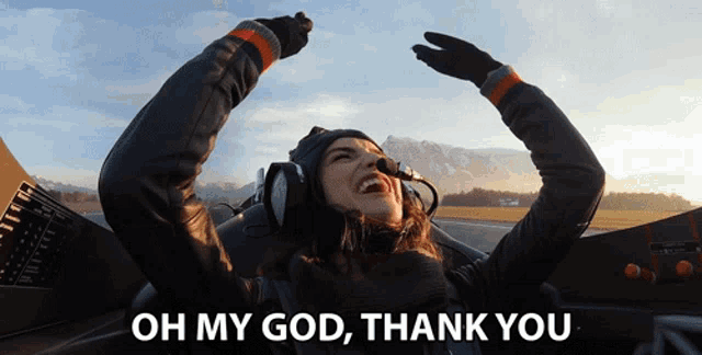 a woman in an airplane with her arms in the air and the words oh my god thank you below her