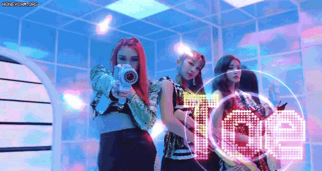 a group of girls are standing next to each other holding guns in front of the word love .