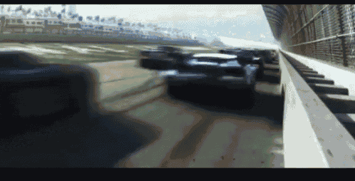 a blurred image of a race track with cars racing on it