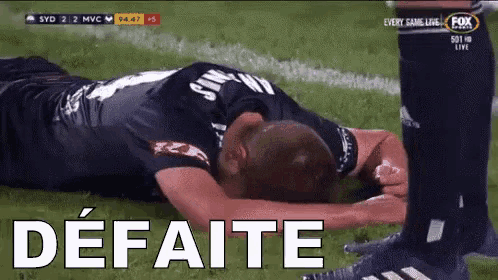 a soccer player is laying on the field with the word defeate written on the bottom