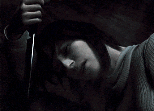 a person is holding a knife in their hand while laying down