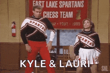 a man and a woman are dancing in front of a sign that says fast lake spartans chess team