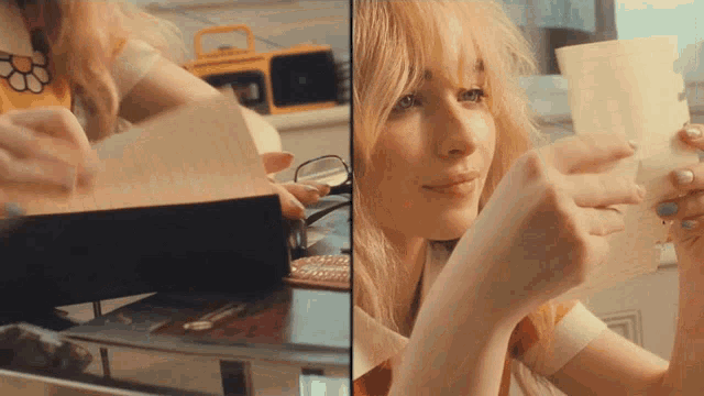 a woman is holding a piece of paper in front of her face