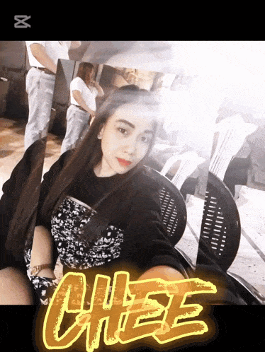 a woman is sitting in a chair with the word chee written on it
