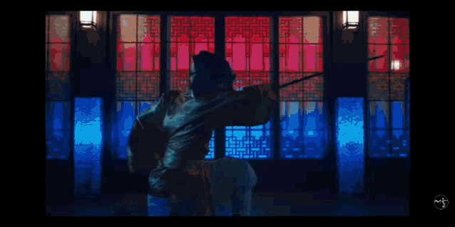 a man in a suit and white shirt is dancing in front of a large building .