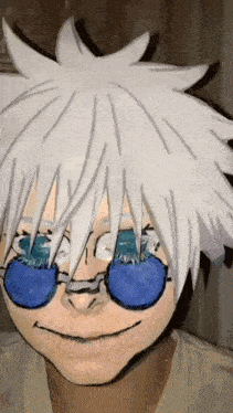 a person with white hair and blue glasses is wearing a mask .