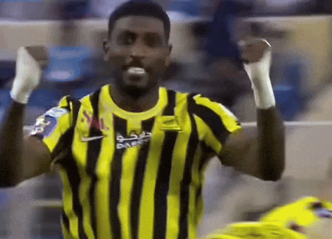a man wearing a yellow and black striped shirt with nike written on it