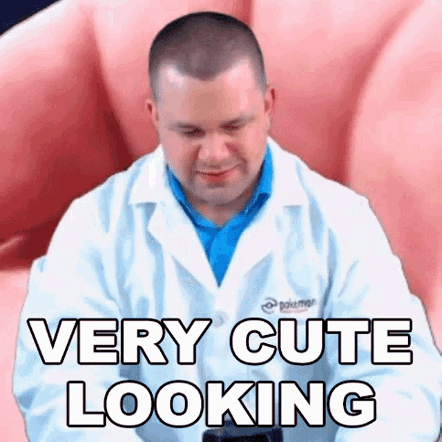 a man in a lab coat is sitting in front of a very cute looking hand .