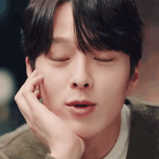 a close up of a man with his eyes closed