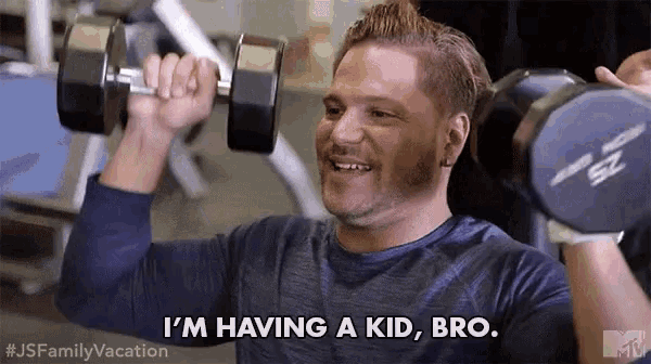 a man is lifting a dumbbell in a gym and saying i 'm having a kid bro .