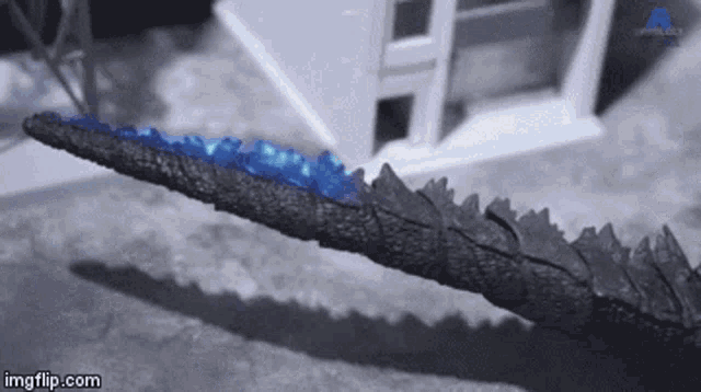 a gif of a dragon 's tail that says imgflip.com at the bottom