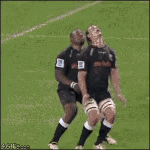 a rugby player is being lifted in the air by his teammates during a game