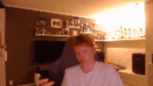 a man in a white shirt is standing in a room