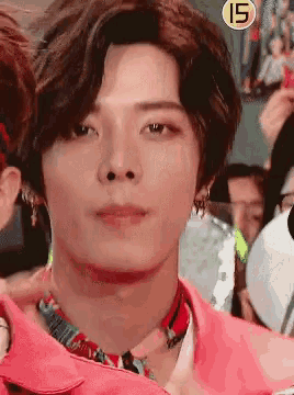 a close up of a man 's face with the number 15 in the background
