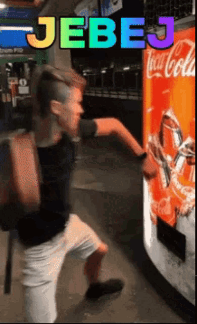 a man is reaching into a coca cola vending machine with the words jebe written above him