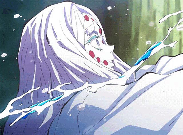 a woman with white hair and red dots on her face is being sprayed with water