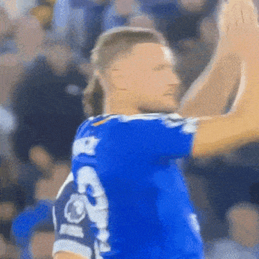 a soccer player wearing a blue jersey with the number 3 on the back
