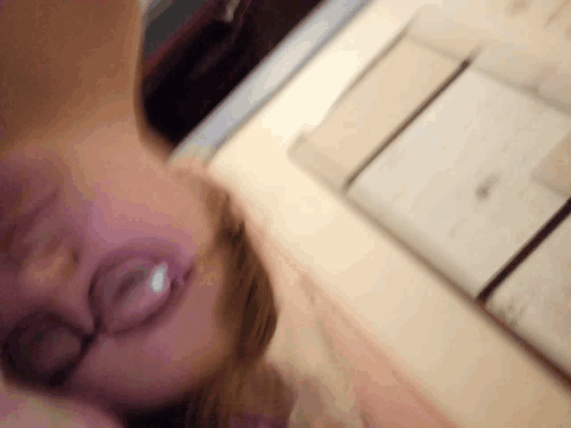 a blurry picture of a woman 's face with a blurred background