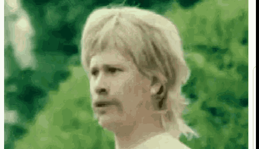 a man with blonde hair and a mustache is wearing a mullet wig and making a funny face .